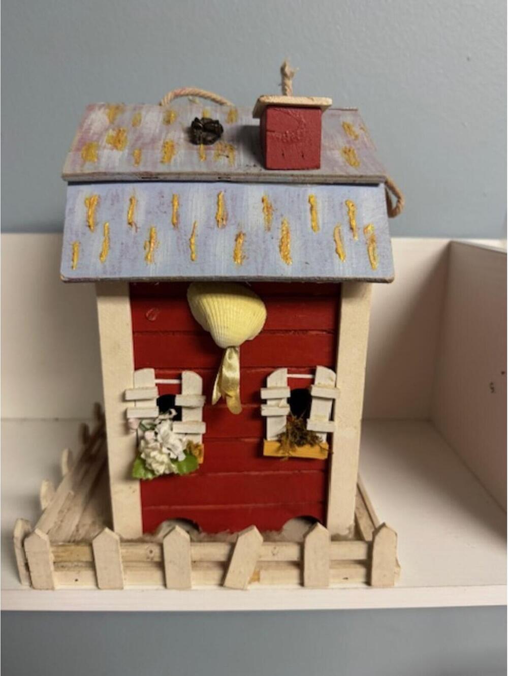 Charming Wooden Birdhouse with Decorative Fence and Floral Accents